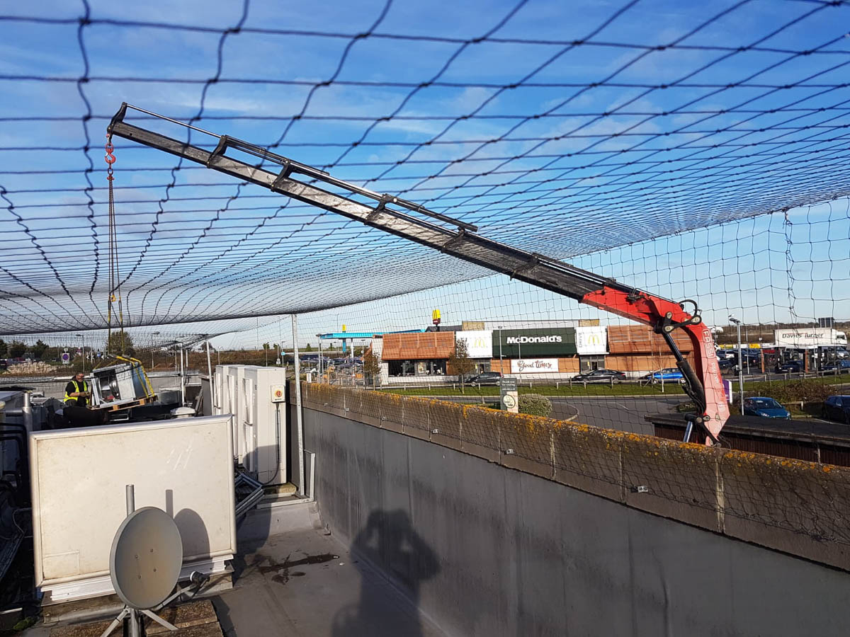 Lifting air conditioner on to a roof in Broadstairs Kent