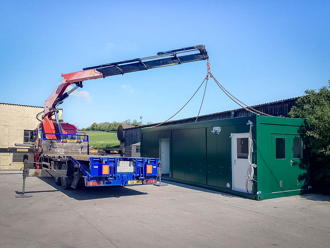 Fassi Crane lifting a 32ft cabin