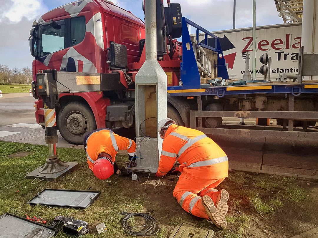 Holding post steady while workmen fit