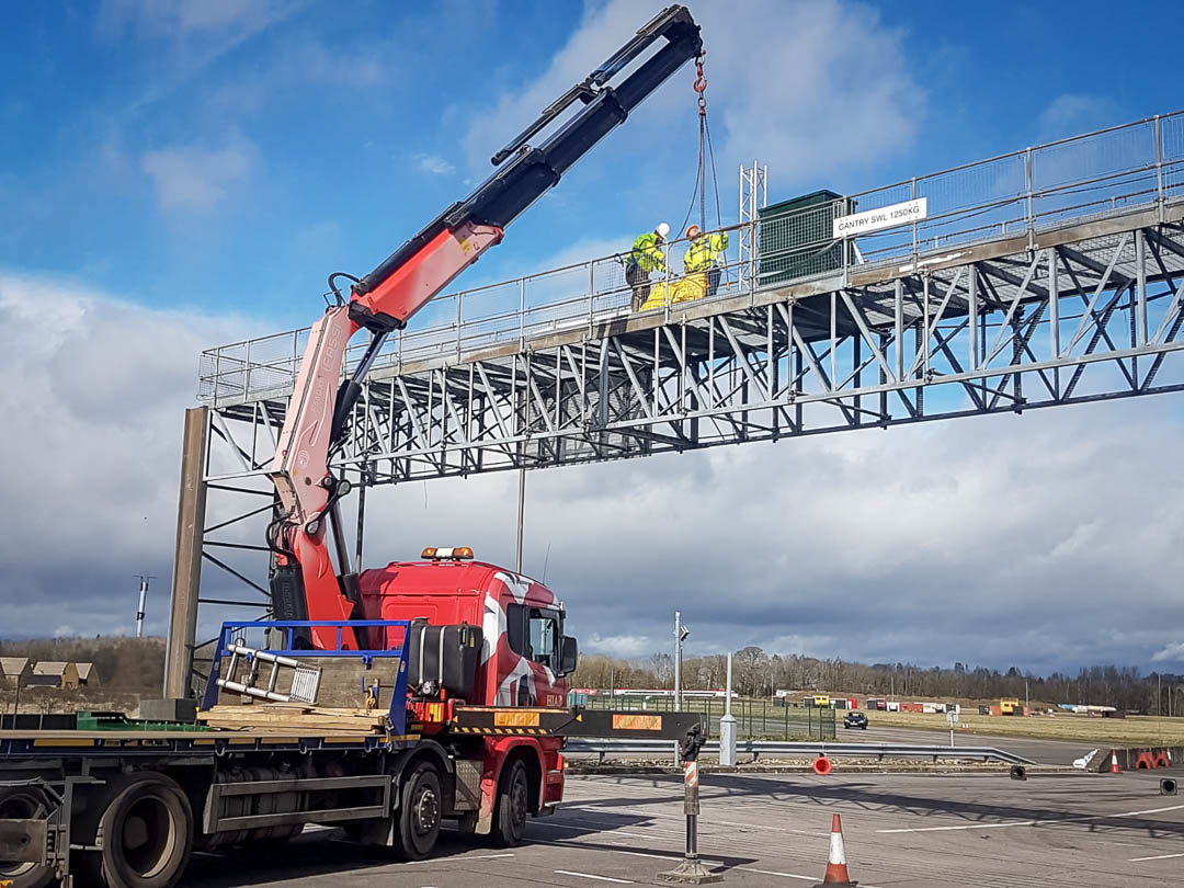 Materials being lifted by Fassi 660 crane up to a gantry in Banbury